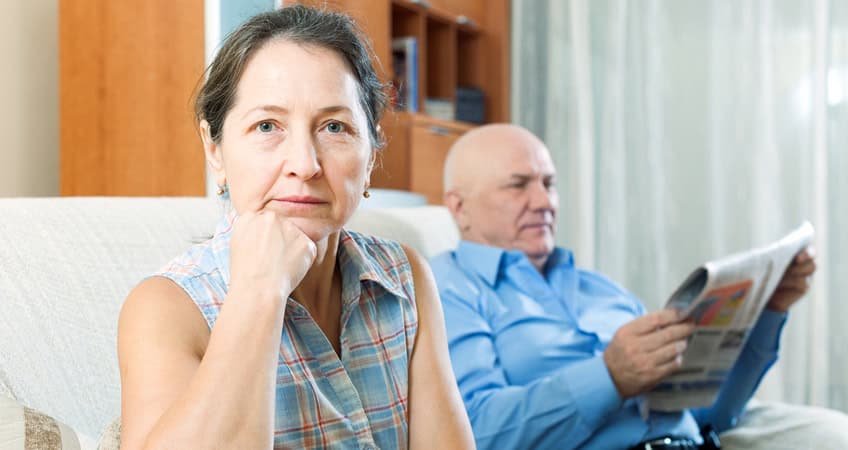 Elderly individuals engaging in a thoughtful discussion at the Senior Citizens Parliament in Ireland, promoting senior rights.