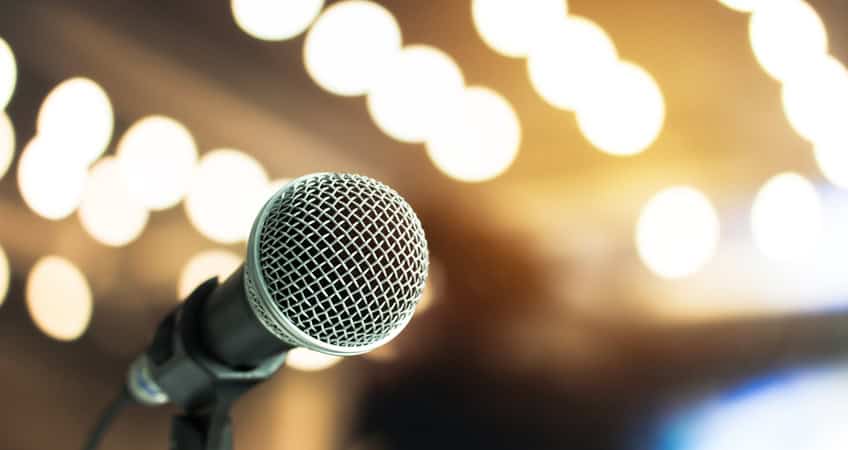 Alt: Microphone set for speakers at Irish Senior Citizens Parliament event.