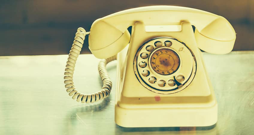 Vintage rotary telephone symbolising senior citizen communication devices.