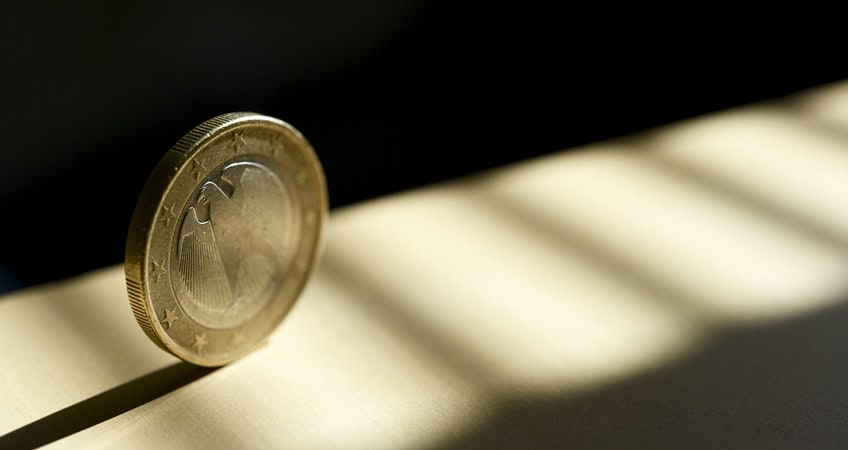 Euro coin and shadow representing senior citizens' financial concerns in Ireland.
