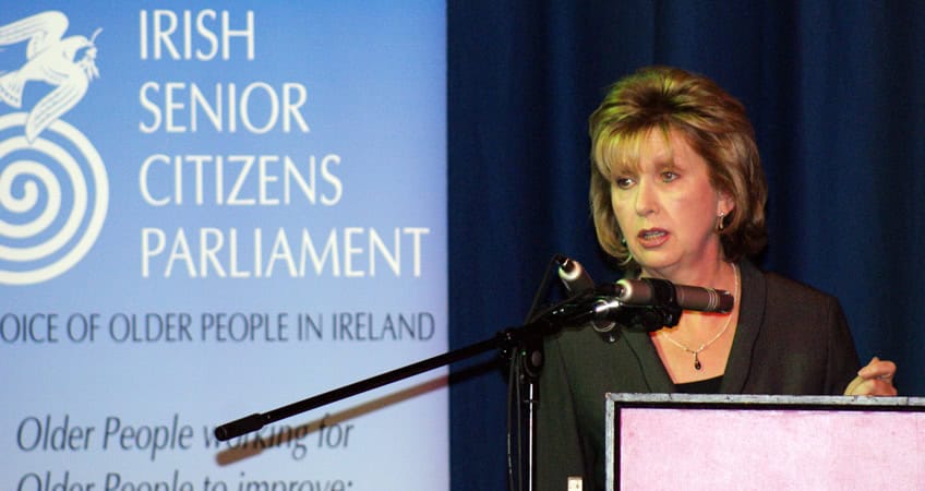Accessible alt text describing the Irish Senior Citizens Parliament event and speaker.