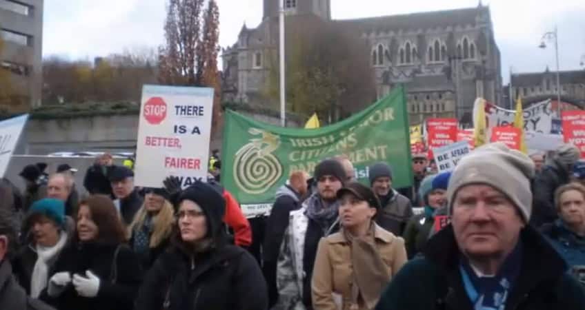 Crowd of seniors protesting for senior rights and fairness at the Irish Senior Citizens Parliament.