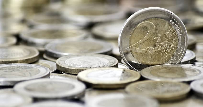 EU2 Euro coin among other Irish coins, symbolising senior citizens' economic issues.