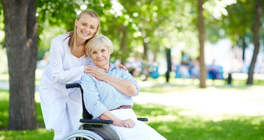 Elderly care and support at Irish Senior Citizens Parliament event in a park.