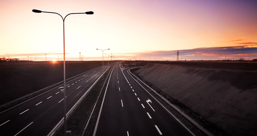 Empty Irish motorway at sunset reflecting opportunities for senior citizens.