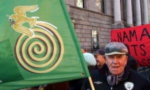 Senior citizens holding a flag at the Irish Senior Citizens Parliament event in Ireland.