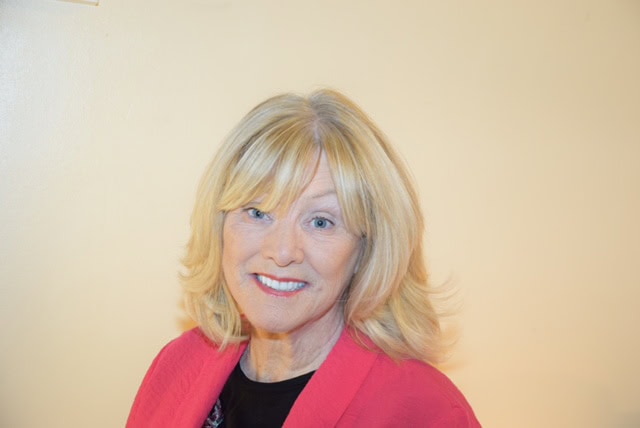 Senior woman speaker at Irish Senior Citizens Parliament event.