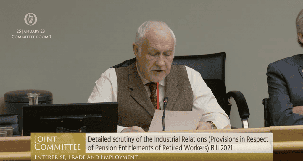Alt text: Elderly man speaking at Irish Senior Citizens Parliament, discussing seniors' rights and pensions.