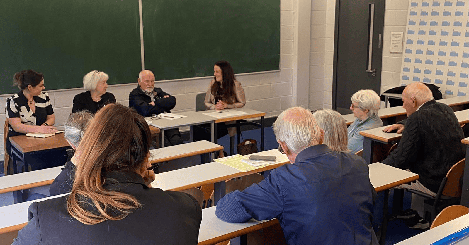 Meeting of senior citizens in a classroom discussion.