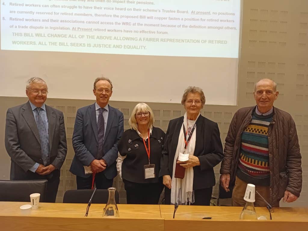 Photo of senior citizens and representatives at Irish Senior Citizens Parliament event.