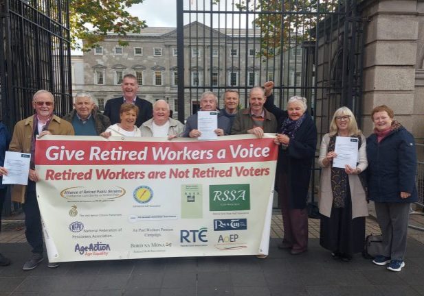 A group of retired workers holding a banner protesting for their voting rights outside the Irish Senior Citizens Parliament building.