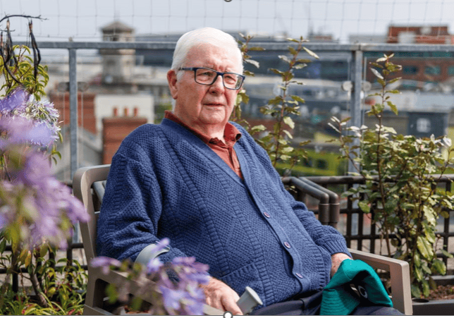 Senior citizen on rooftop garden at Irish Senior Citizens Parliament.