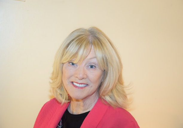 Senior woman speaker at Irish Senior Citizens Parliament event.