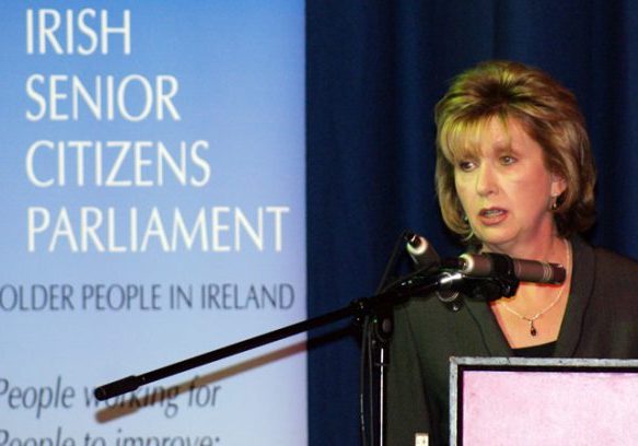 Accessible alt text describing the Irish Senior Citizens Parliament event and speaker.